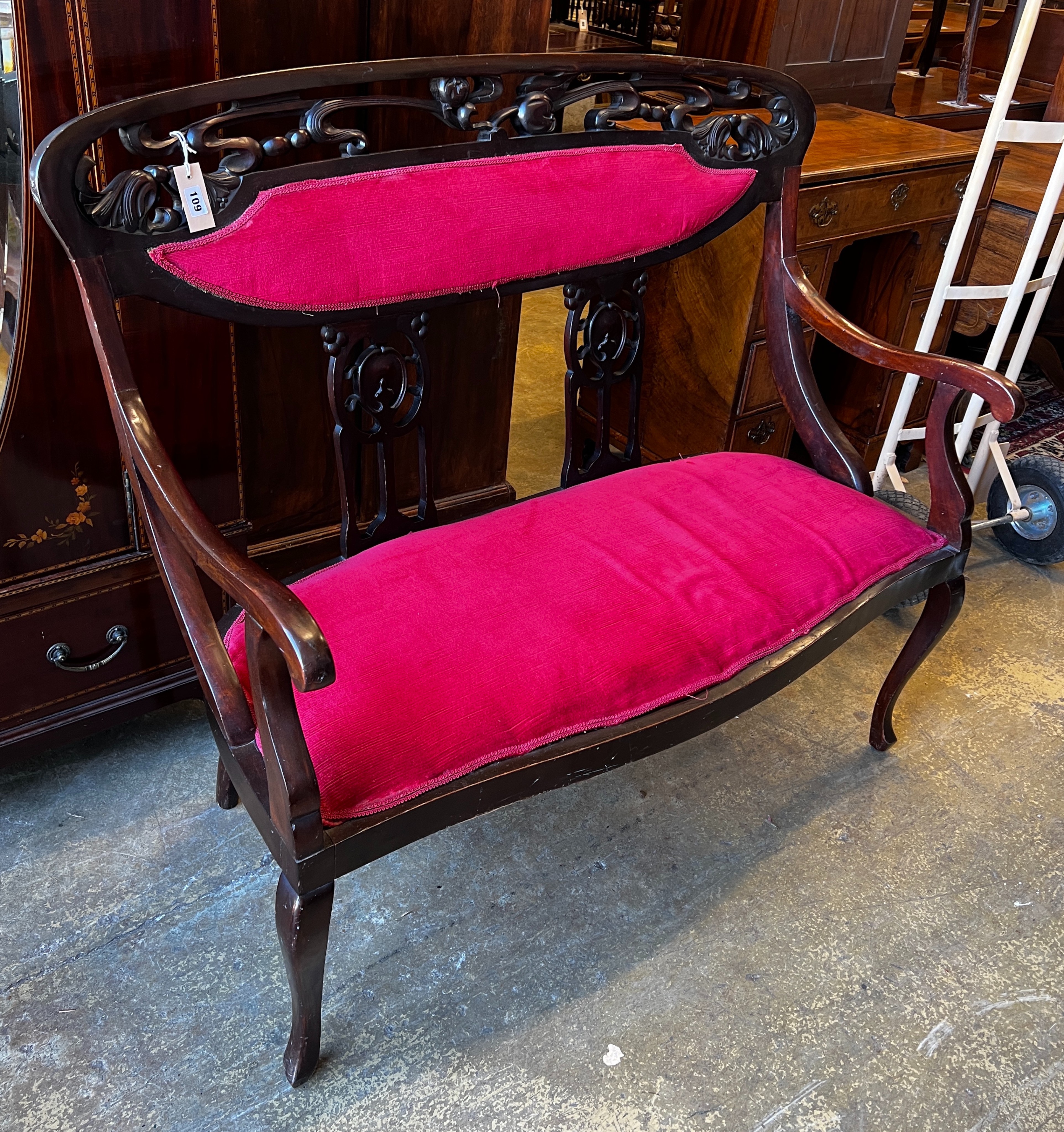 A late Victorian Art Nouveau mahogany upholstered salon settee, length 112cm, depth 50cm, height 106cm